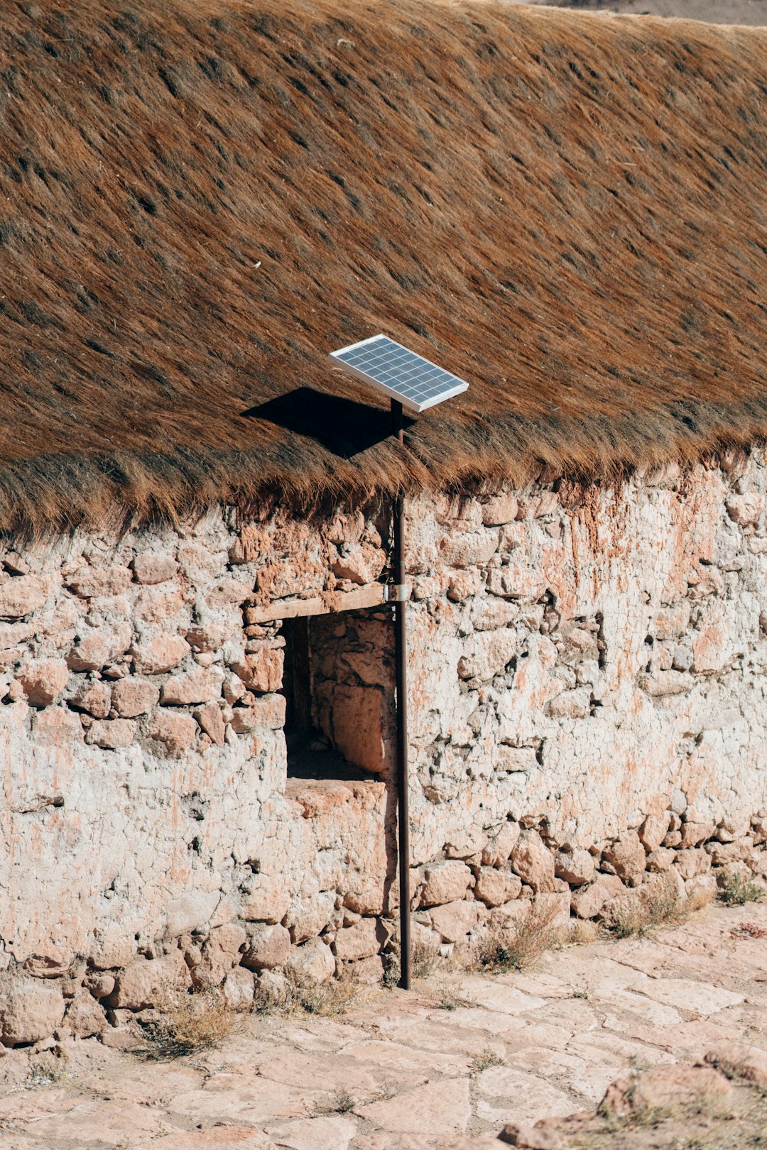 Solar panel with natural roof and stone wall